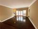 Bright living room featuring hardwood floors, neutral paint, and direct patio access at 5005 Johns Creek Ct, Alpharetta, GA 30022