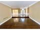 Spacious living room with hardwood floors, crown molding, and bright entryway at 5005 Johns Creek Ct, Alpharetta, GA 30022