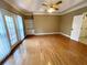 Bright and airy bedroom featuring a tray ceiling, hardwood floors, and an abundance of natural light at 5005 Johns Creek Ct, Alpharetta, GA 30022