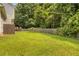 Lush, green backyard featuring a well-maintained lawn, wooden privacy fence, and mature trees at 8690 Cedar Creek Rdg, Riverdale, GA 30274