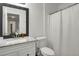 Clean bathroom with white vanity, updated fixtures, and a shower-tub combination at 8690 Cedar Creek Rdg, Riverdale, GA 30274