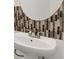 Close-up of bathroom sink with decorative tile backsplash and modern faucet at 8690 Cedar Creek Rdg, Riverdale, GA 30274