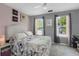 Bedroom featuring soft, muted colors, modern decor, and comfortable bedding at 8690 Cedar Creek Rdg, Riverdale, GA 30274