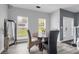 Cozy dining area featuring modern decor, wood table, and natural light at 8690 Cedar Creek Rdg, Riverdale, GA 30274
