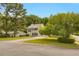Charming two-story home with a well-manicured lawn, mature trees, and a welcoming driveway at 8690 Cedar Creek Rdg, Riverdale, GA 30274
