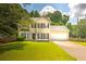 Charming two-story home with a well-manicured lawn and a two-car garage at 8690 Cedar Creek Rdg, Riverdale, GA 30274