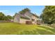 Rear exterior view showcasing the home's siding, roofline, backyard, and deck at 8690 Cedar Creek Rdg, Riverdale, GA 30274