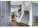 Inviting foyer with hardwood floors, gray walls, and a staircase with white banister at 8690 Cedar Creek Rdg, Riverdale, GA 30274