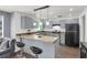 Well-lit kitchen featuring modern gray cabinets and stainless steel gas range at 8690 Cedar Creek Rdg, Riverdale, GA 30274