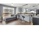 Modern kitchen with gray cabinets, stainless steel appliances, and bar stool seating at 8690 Cedar Creek Rdg, Riverdale, GA 30274