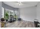 Bright living room featuring stylish gray floors, large windows, and modern decor at 8690 Cedar Creek Rdg, Riverdale, GA 30274