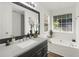 Bright main bathroom with garden tub, dual sink vanity, and modern finishes at 8690 Cedar Creek Rdg, Riverdale, GA 30274