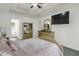 Bright main bedroom featuring tray ceiling, TV, and ensuite bathroom at 8690 Cedar Creek Rdg, Riverdale, GA 30274