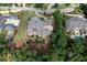 An aerial view of a vast gray-roofed home with mature trees, and manicured landscaping at 9695 Almaviva Dr, Alpharetta, GA 30022