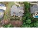 An aerial view of a vast gray-roofed home with mature trees, and manicured landscaping at 9695 Almaviva Dr, Alpharetta, GA 30022