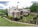 Brick home showcasing manicured landscaping, fenced yard, and multi-level structure at 9695 Almaviva Dr, Alpharetta, GA 30022