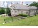 Brick home featuring lush landscaping, mature trees, and a well-maintained sloping lawn at 9695 Almaviva Dr, Alpharetta, GA 30022