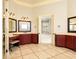 Elegant primary bathroom with dual vanities, decorative mirrors, and marble tile flooring at 9695 Almaviva Dr, Alpharetta, GA 30022