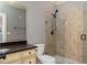 Bathroom featuring glass shower, beige tile and granite countertop at 9695 Almaviva Dr, Alpharetta, GA 30022