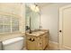 Bathroom featuring a large mirror, granite countertop, and toilet at 9695 Almaviva Dr, Alpharetta, GA 30022
