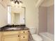 Bathroom featuring a granite vanity, a large decorative mirror and a tiled shower-tub combo at 9695 Almaviva Dr, Alpharetta, GA 30022