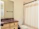 Classic bathroom features a vanity with a granite countertop and a shower with a patterned curtain at 9695 Almaviva Dr, Alpharetta, GA 30022