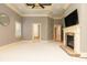 Large bedroom featuring fireplace, tray ceiling, and an abundance of natural light at 9695 Almaviva Dr, Alpharetta, GA 30022