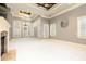 Large bedroom boasts a stone fireplace, recessed ceiling, and an abundance of natural light at 9695 Almaviva Dr, Alpharetta, GA 30022