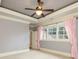 Bedroom with plush carpeting and window featuring pink drapes at 9695 Almaviva Dr, Alpharetta, GA 30022