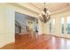 Dining room offering hardwood floors, decorative trim, and a view of the grand foyer and staircase at 9695 Almaviva Dr, Alpharetta, GA 30022