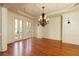 Elegant dining room featuring hardwood floors, decorative molding, and a stylish chandelier at 9695 Almaviva Dr, Alpharetta, GA 30022