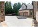 Long driveway leading to a multi-car garage, with a basketball hoop visible at 9695 Almaviva Dr, Alpharetta, GA 30022