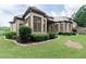 Beautiful brick home featuring manicured landscaping and lush green lawn at 9695 Almaviva Dr, Alpharetta, GA 30022