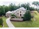 Beautiful two-story stone home with a well-manicured lawn and lush trees at 9695 Almaviva Dr, Alpharetta, GA 30022