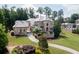 Gorgeous stone home with lush landscaping, mature trees and a winding driveway at 9695 Almaviva Dr, Alpharetta, GA 30022