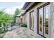 Stone patio with wrought iron railing and glass doors at 9695 Almaviva Dr, Alpharetta, GA 30022