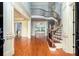 Grand foyer with hardwood floors, a curved staircase, and abundant natural light at 9695 Almaviva Dr, Alpharetta, GA 30022