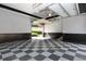 Spacious garage featuring a checkered floor and ample space for vehicles and storage at 9695 Almaviva Dr, Alpharetta, GA 30022
