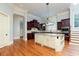 Gourmet kitchen with a center island, custom cabinets, granite counters, and modern stainless steel appliances at 9695 Almaviva Dr, Alpharetta, GA 30022