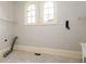 Bright laundry room featuring arched windows, tile floors and folding counter at 9695 Almaviva Dr, Alpharetta, GA 30022