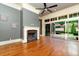 Bright living room featuring a fireplace, hardwood floors, and sliding glass doors leading to the backyard at 9695 Almaviva Dr, Alpharetta, GA 30022
