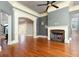 Living room showcasing hardwood floors, elegant moldings, a marble fireplace, and an open floor plan at 9695 Almaviva Dr, Alpharetta, GA 30022