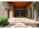 Spacious covered patio with stone flooring and gas heaters is great for entertaining and relaxing at 9695 Almaviva Dr, Alpharetta, GA 30022