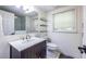 Well-lit bathroom featuring a modern vanity, a window, and access to the shower at 1393 Sagewood Cir, Stone Mountain, GA 30083
