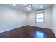 Bedroom features hardwood floors, ceiling fan, and a window with natural light at 1393 Sagewood Cir, Stone Mountain, GA 30083