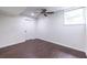 This bedroom features hardwood floors, a ceiling fan, and a bright window at 1393 Sagewood Cir, Stone Mountain, GA 30083