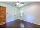 Bedroom featuring hardwood floors, a window and both a wooden and white doors at 1393 Sagewood Cir, Stone Mountain, GA 30083
