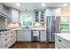 Bright kitchen with stainless steel refrigerator, sleek cabinets, and modern countertops at 1393 Sagewood Cir, Stone Mountain, GA 30083