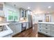 Well-lit kitchen featuring stainless steel appliances, stylish cabinets, and a view to the backyard at 1393 Sagewood Cir, Stone Mountain, GA 30083