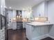 Kitchen features stainless appliances, breakfast bar, gray backsplash, and sleek white cabinets at 1393 Sagewood Cir, Stone Mountain, GA 30083